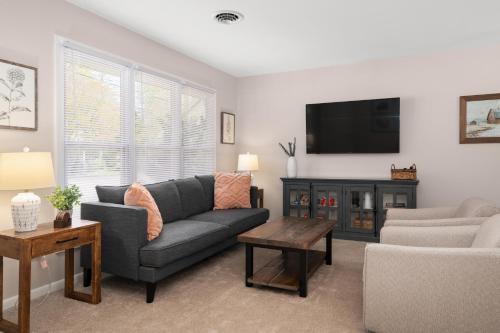 a living room with a couch and a tv at Salisbury Cottage in Salisbury