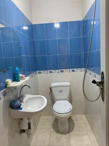 a blue and white bathroom with a toilet and a sink at BENSASSI Urban Escape Premium in La Marsa