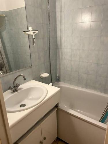 une salle de bain avec un lavabo, un miroir et une baignoire dans l'établissement Agréable Studio Sanary-sur-mer, à Sanary-sur-Mer
