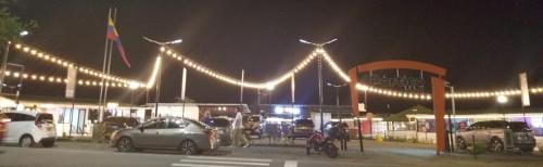 a parking lot at night with cars and lights at APARTAESTUDIO en el Norte de Armenia, en la via a Salento y Filandia Con parqueadero de carro in Armenia