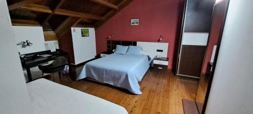 a bedroom with a white bed and a piano at Casa Buda Conors & Spa in Foz
