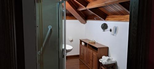 a bathroom with a shower and a toilet and a sink at Casa Buda Conors in Foz