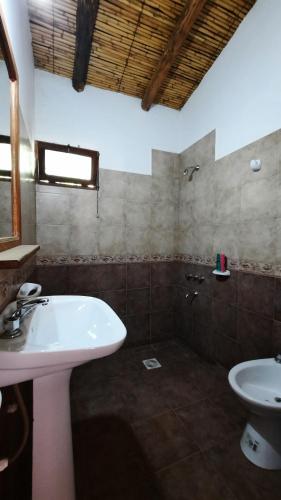 a bathroom with a sink and a toilet at La casona de Adobe in San José