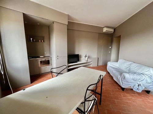 a living room with a bed and a television at Serravalle Castle Apartment in Serravalle