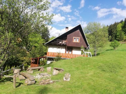 a house on top of a grassy hill at Chata na Čertove in Štôla