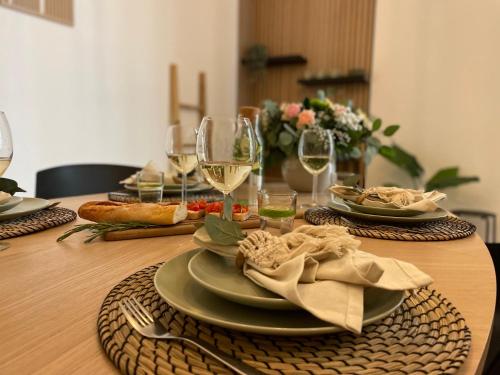 a table with plates of food and glasses of wine at Bamboo City in Magdeburg