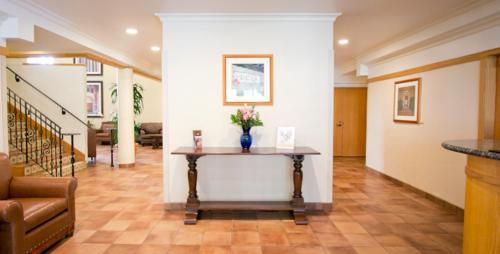 a living room with a table with flowers on it at The Inn at UCLA in Los Angeles