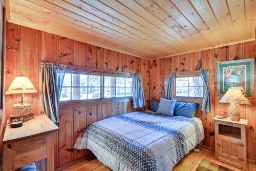 a bedroom with a bed in a wooden room at Autumnsong Fireside Cabin Near Dtwn Buena Vista! in Buena Vista