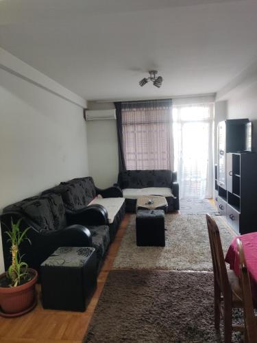 - un salon avec un canapé noir et une télévision dans l'établissement Kralj, à Prokuplje