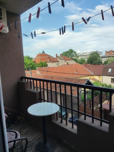 a balcony with a table and a view of a building at Kralj in Prokuplje