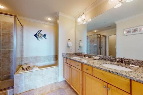 a bathroom with two sinks and a shower at Holiday Isle 413 in Dauphin Island