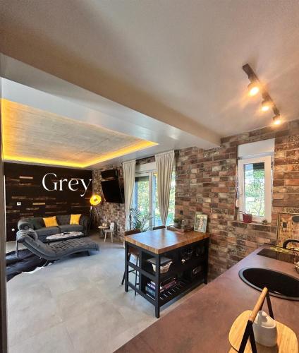 a large living room with a brick wall at Secret Place apartments, luxury and spa in Zdenci Brdovečki