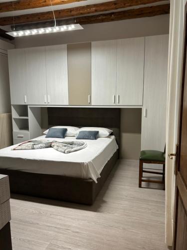 1 dormitorio con 1 cama grande y 1 silla en Larocca Tourist Home 3, en Bassano del Grappa