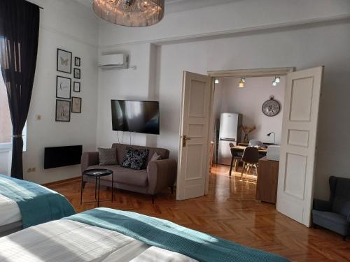 a room with a bed and a couch and a table at Apartment Hesperia in Zagreb