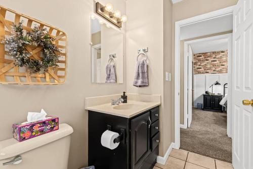 a bathroom with a sink and a mirror at Cozy 3BR Home Friendly City of Hazel Park in Hazel Park