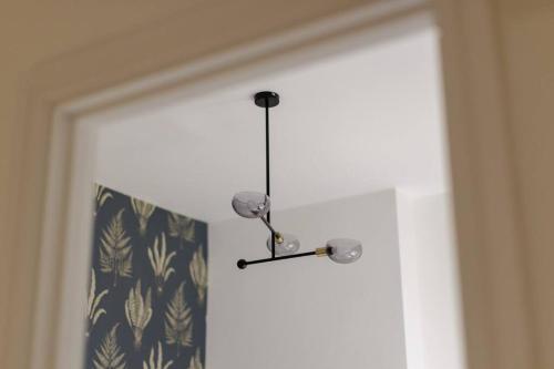 a chandelier hanging over a door with a curtain at 82 Van Road in Caerphilly