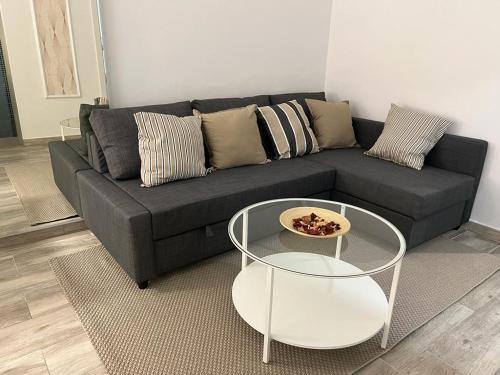 a living room with a black couch and a table at DON LEONE Hotel in Alginet