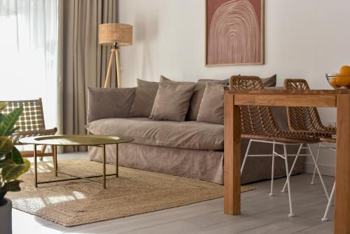 a living room with a couch and a table at Luxury aparment in casilla de costa with Jacuzzi- Follow the sun in La Oliva