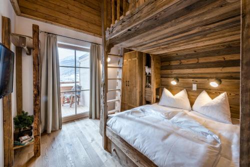 a bedroom with a large bed and a window at Das Kleinarl in Kleinarl