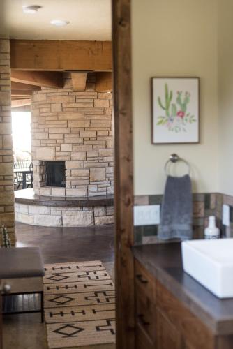 a bathroom with a sink and a fireplace at Escalante Cliff House in Escalante