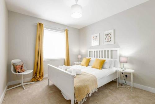 a bedroom with a white bed and a window at 14 Southfield - 3 Bed/2 Bath - Parking in St. Andrews