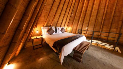 a bedroom with a bed in a bamboo wall at Ceiba by Masaya Collection in San Agustín