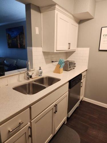 a kitchen with white cabinets and a sink at Blue Shark *B542* @ Medical Center Modern 1BR King Apartment in Houston