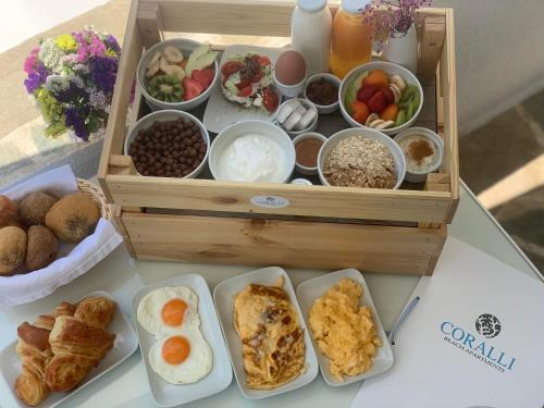 a box of breakfast foods on a table at Coralli Beach Apartments in Mikri Vigla