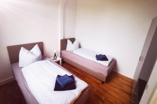 two beds in a small room with wood floors at ehemalige Kirche in neuem Glanz in Oranienbaum-Wörlitz