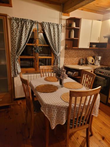 a kitchen with a table and chairs in a room at Dom pod jabłonkami in Zarzecze