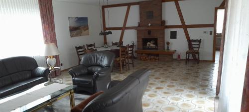 a living room with a couch and chairs and a table at Ferienwohnung Aue Deußen in Erftstadt