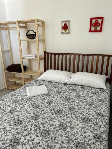 a bedroom with a bed with a black and white blanket at Apartamento a beira-mar Natal in Natal