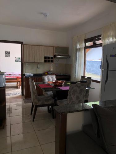 eine Küche und ein Esszimmer mit einem Tisch und Stühlen in der Unterkunft Casa vermelha, sitio pousada vô maneca in Timbó