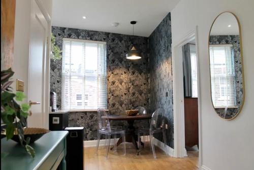 a dining room with a table and a mirror at Clement House, York, Free EV and parking in York