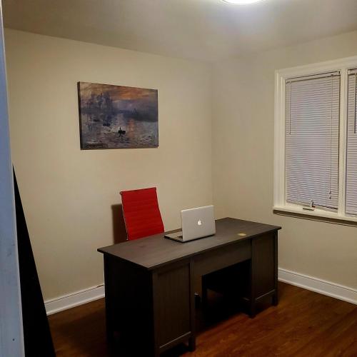 an office with a desk with a laptop on it at beautiful 2 level bungalow in a posh neighborhood. in Toronto
