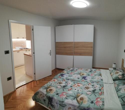 a bedroom with a large bed and a closet at Apartma Mi-Mari2 in Koper