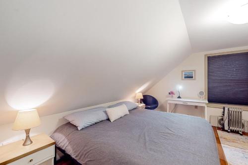 a bedroom with a bed and a window at Parker Pond's Perch in Poland Spring