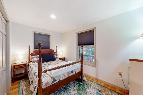 a bedroom with a bed and a window at Parker Pond's Perch in Poland Spring