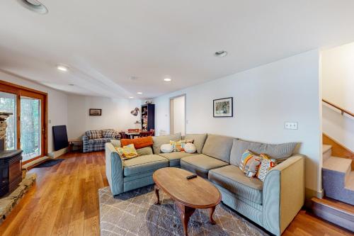a living room with a couch and a table at Parker Pond's Perch in Poland Spring