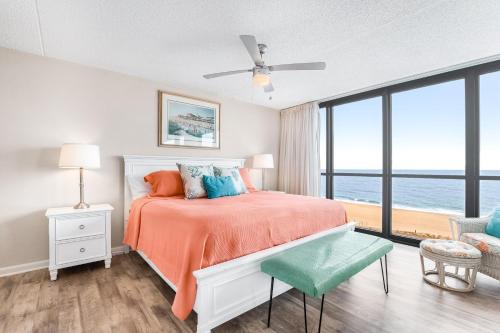 a bedroom with a bed with an orange bedspread at Golden Sands 607 in Ocean City