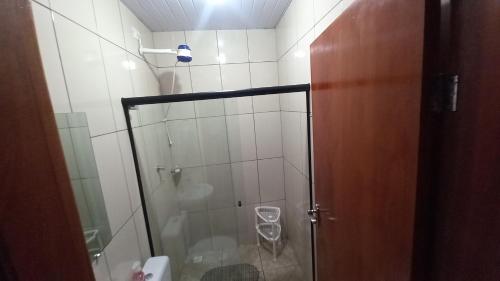 a bathroom with a shower with a glass door at Casa Rota das 3 Fronteiras in Foz do Iguaçu