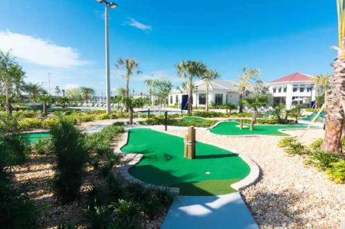 a golf course at the resort with palm trees at Family 4BR w Private Pool near Disney Parks in Kissimmee