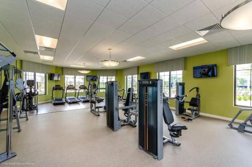 a gym with treadmills and elliptical machines at Family 4BR w Private Pool near Disney Parks in Kissimmee