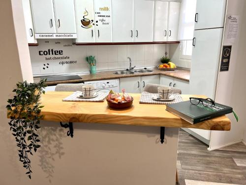 una cocina con una mesa con un bol de fruta. en AGUA DULCE , Apartamento Rural, en Herrera del Duque