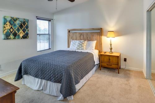 a bedroom with a bed and a lamp on a table at Laughlin Retreat with Pool 2 Mi to Big Bend! in Laughlin