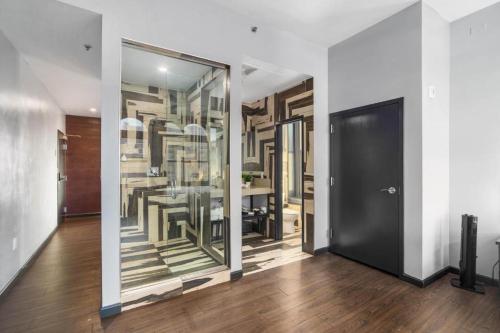 a dining room with a table and a black door at Good Hotels Downtown Denver in Denver