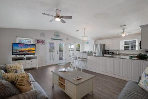 a kitchen and living room with a couch and a table at Canario Cottage Home in Anna Maria