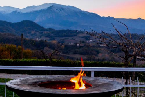 a fire pit with a view of the mountains at [vista Sibillini] Villa Amici in Verri
