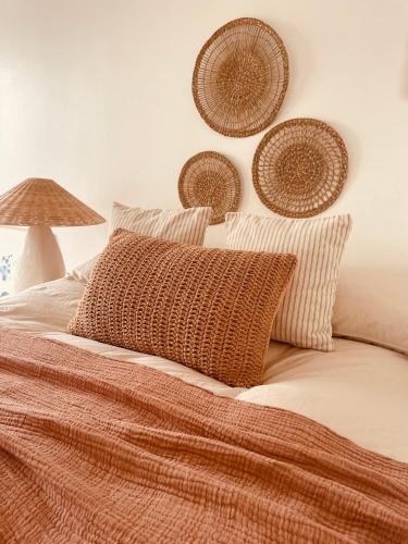 a bed with a pillow and baskets on the wall at The Maiden Studio. Derry city. Studio Apartment. in Derry Londonderry