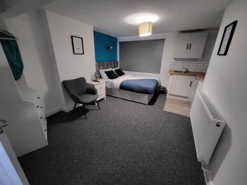 a hotel room with a bed and a desk and a chair at Premier Studios Nottingham - Tring Vale in Nottingham